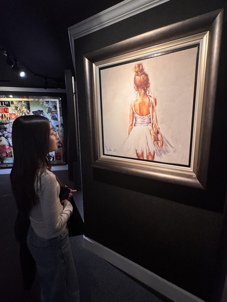 One of my daughters looking at a ballerina painting at an art gallery in Downtown Carmel