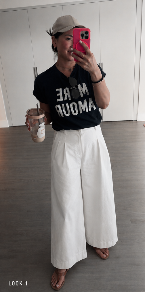 Luxemix wide-leg white parachute pants styled with a navy More Amour graphic tee, brown thong sandals, and an iced coffee